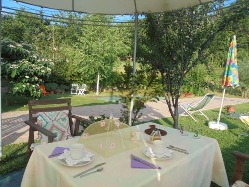a table with a white table cloth on it at B&B Alla Borgata in Boves