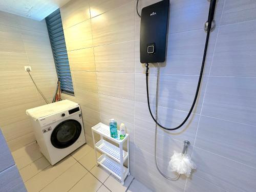 a bathroom with a washing machine and a washer at 3 Towers Jalan Ampang By Serenity Vacation Homes in Kuala Lumpur