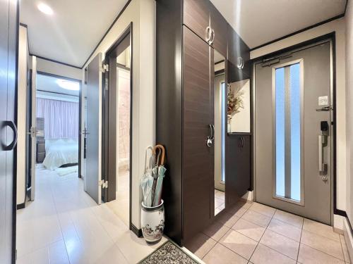 a hallway with a door and a room with a bed at 4mins to Station 4 Lines for used Direct to Shinjuku Ikebukuro every spots Big House Family 3 Bedrooms Max for 8 people in Tokyo