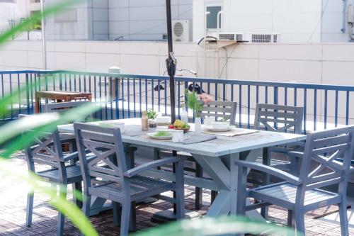 a blue table and chairs on a balcony at LN15 RICCA 三宮5分! 屋上バーベキュー可能!キッチン付パーティ向コンド roof top BBQ in Kobe