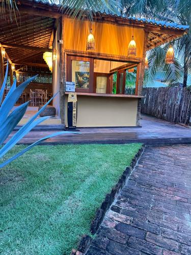 a house with a lawn in front of it at Pousada Vento do Kite in Barra Grande