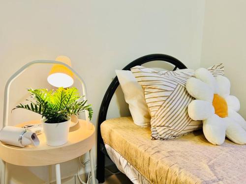 a teddy bear sitting on a bed next to a table at JB-Bukit Indah 8-15pax Spacious Home! 5min to Aeon in Johor Bahru