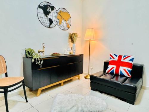 a living room with a black leather chair and a desk at JB-Bukit Indah 8-15pax Spacious Home! 5min to Aeon in Johor Bahru