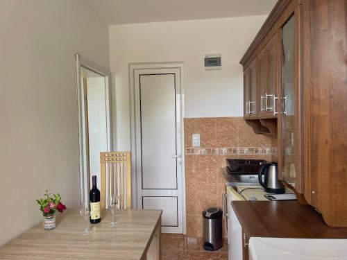 a kitchen with a counter with a bottle of wine at Kuća Radović in Budva