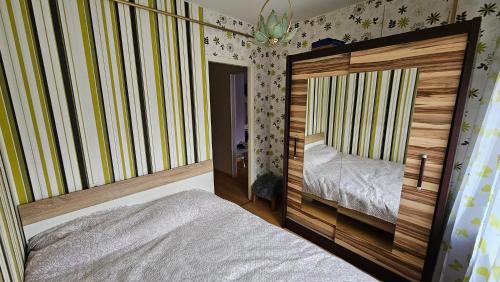 um pequeno quarto com uma cama e um espelho em Smile Appartment em Tartu
