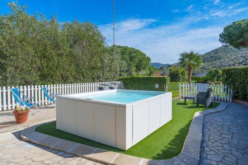 a hot tub in the backyard of a house at Marina VIP in Marciana