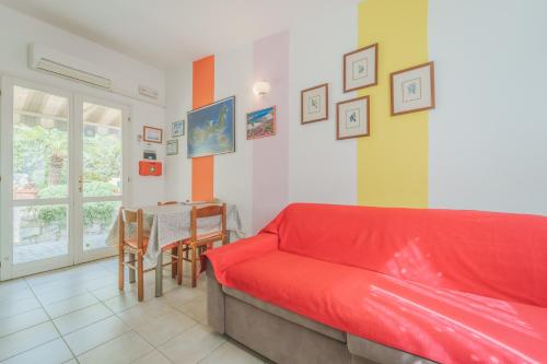 a living room with a red couch and a table at Marina VIP in Marciana