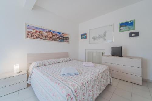 a bedroom with a bed and a tv in it at Marina VIP in Marciana