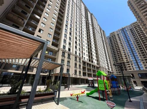 a playground in a city with tall buildings at Apartments near the sea in Odesa