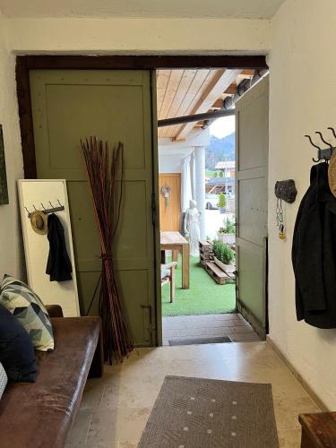 a living room with a door open to a yard at Ferienwohnung Bergblick in Kössen