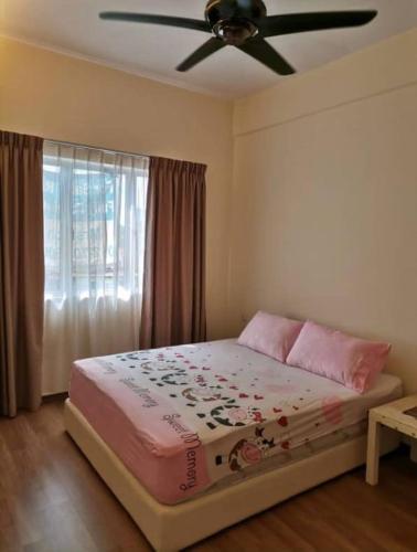 een slaapkamer met een bed en een plafondventilator bij Sweet Homestay Golden Shower Apartment in Melaka