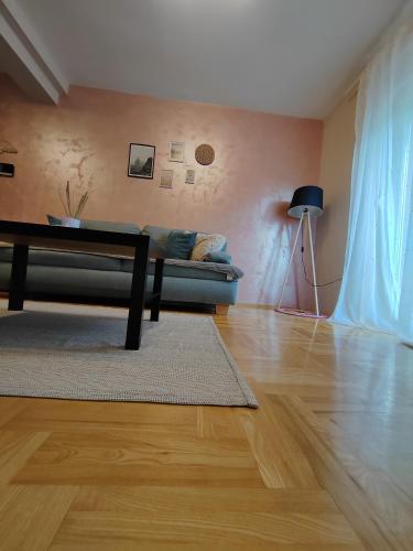 a living room with a couch and a table at Apartman_Krstić_1 in Subotica