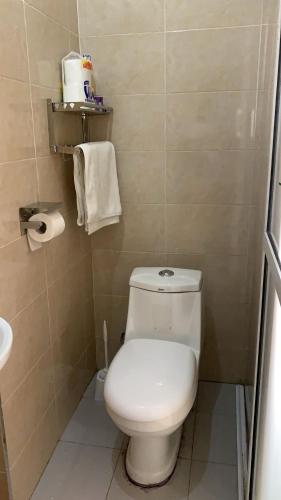 a small bathroom with a toilet and a sink at The Cozy Home in Nairobi