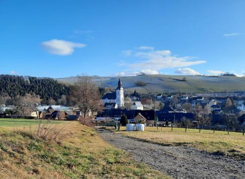 a small town with a church in a field at Ferienwohnung Schwibbogen in Drebach