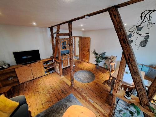 a living room with wooden floors and a tv at Zum Jandel in Boppard