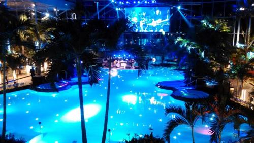 a view of a pool at a theme park at night at ForestView Dream Apartment in Bucharest
