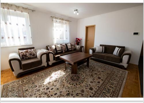 a living room with couches and a coffee table at The View Apartments in Ilijaš