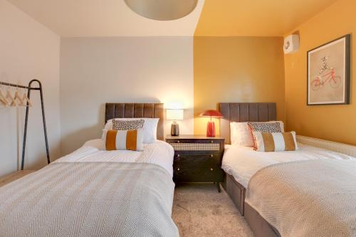 two beds sitting next to each other in a bedroom at Ann’s Place - 2 Bed House Central Romford - Free Parking & Garden in Romford