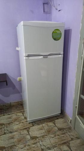 a white refrigerator in a corner of a room at El Toro in San Fernando del Valle de Catamarca