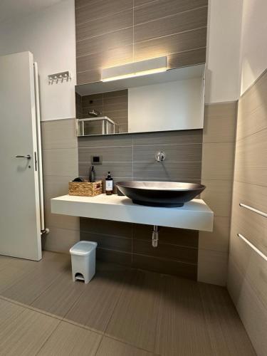 a bathroom with a bowl sink on a counter at La casa di Yasmin_Pescara centro in Pescara