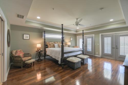 Royal Palm House في كابتيفا: غرفة نوم بسرير مظلة وكرسي