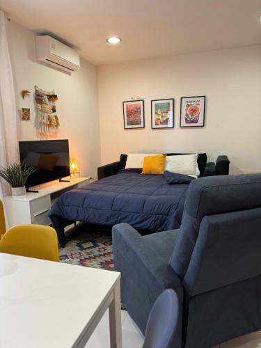 a living room with a bed and a couch at Aveiro Escapades Central City in Aveiro