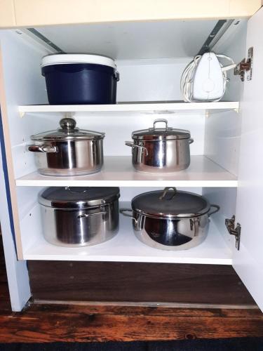 a shelf full of pots and pans in a kitchen at Zum Jandel in Boppard