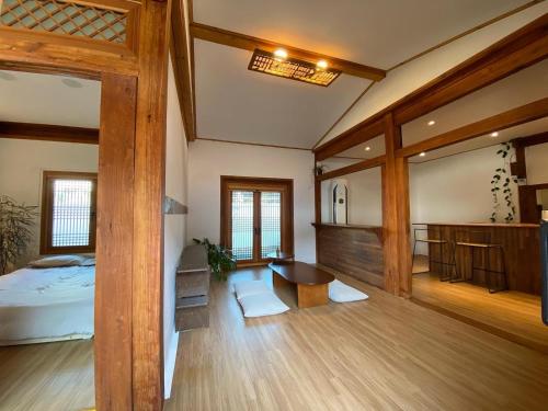 a bedroom with a bed and a table in a room at Stay Sayu Hanok in Gyeongju