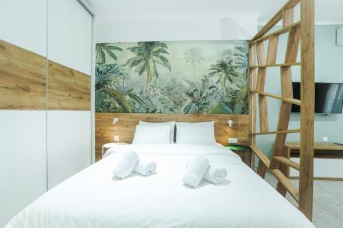 a bedroom with a large white bed with a ladder at the 203 in Giannitsa