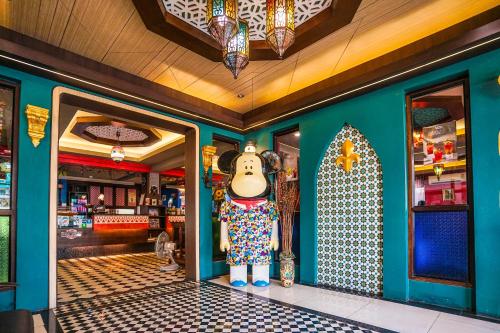 a shop with a statue of a cow in the doorway at Blue cafe Apartments in Chiang Mai