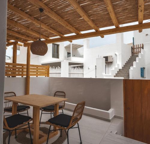 a dining room with a table and chairs at Alonia Suites in Naousa