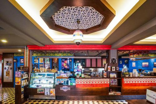 a restaurant with a counter and a food court at Blue cafe Apartments in Chiang Mai