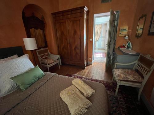 a bedroom with a bed and a bathroom with a sink at Cocooning Avignon in Avignon