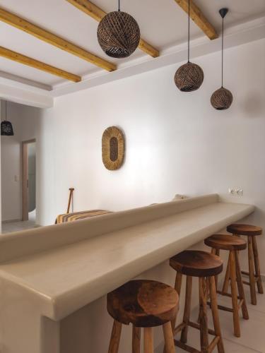 a kitchen with a large marble counter and stools at Alonia Suites in Naousa