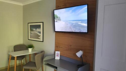 a room with a flat screen tv on a wall at Willa Abrazja - wypoczynek dla dorosłych in Jastrzębia Góra
