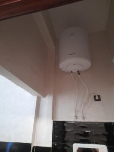 a room with a light hanging from the ceiling at Apartment Surf in Skhirat