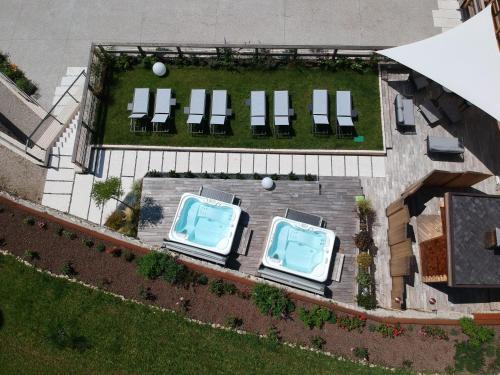 an overhead view of two swimming pools in a yard at ARPA DI PIETRA - Luxury B&B SPA BIO - Adults Only in Mori