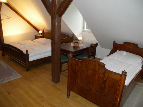 a bedroom with two beds and a table with a desk at Penzion Záhornice 