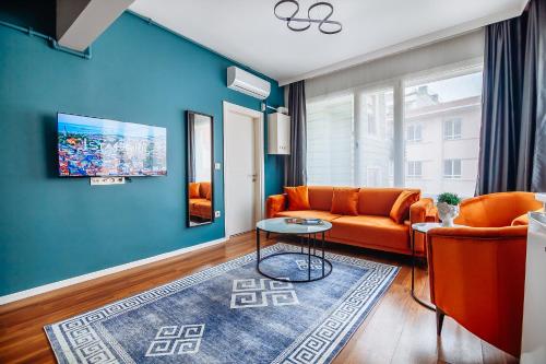 a living room with orange furniture and a blue wall at Taksim Wonder Suites in Istanbul
