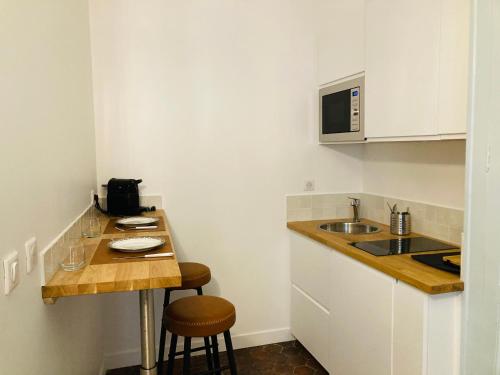 a small kitchen with a counter and a sink at AU LION D OR in Auxerre