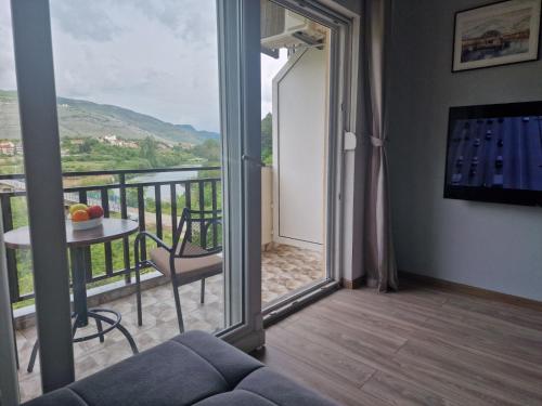 a living room with a view of a balcony at Studio apartmani Milović in Trebinje