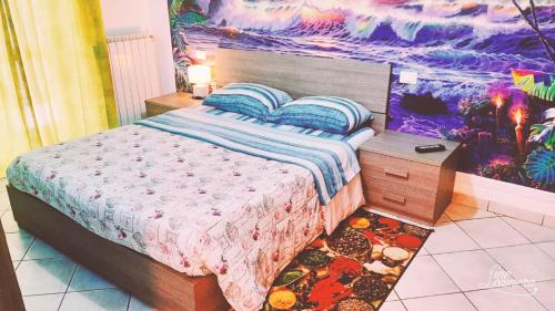 a bedroom with a bed and a painting on the wall at Casa Maria in Cigole