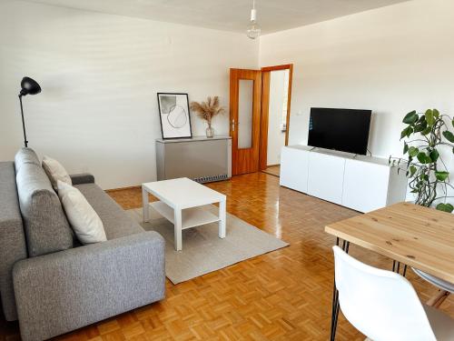 uma sala de estar com um sofá e uma televisão em Das Schmiedhofer in Bleiburg em Bleiburg
