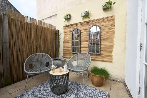two chairs and a table on a patio at Surf Cottage in Cromer