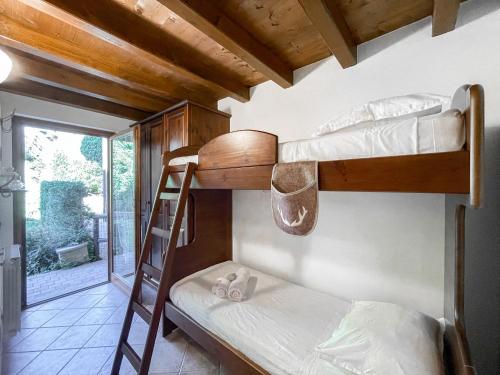 2 Etagenbetten in einem Zimmer mit Fenster in der Unterkunft Villetta a schiera, giardino privato e box doppio in San Pietro
