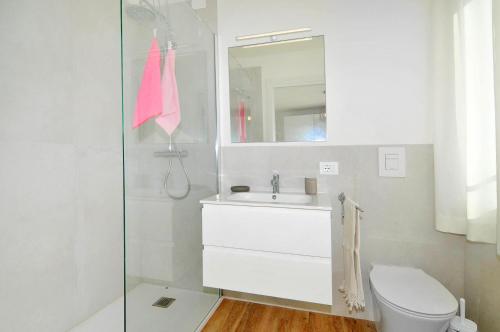 a bathroom with a toilet and a sink and a mirror at Bellavista in Caorle