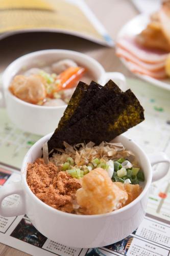 a bowl of soup with a piece of food in it at Cambridge Tainan Hotel in Tainan