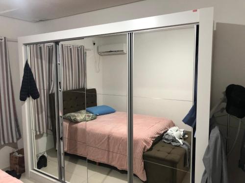 een kleine slaapkamer met een bed en een spiegel bij Apartamento Centro Histórico in Porto Alegre