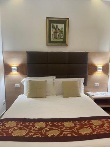 a bedroom with a large bed with a black headboard at Bnb giglio 999 in Prato