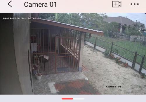 a building with a dog in a cage at Vakantiehuis Paramaribo in Paramaribo